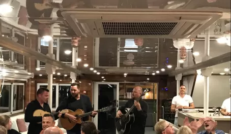 A local band serenades passengers during the Captain's Dinner