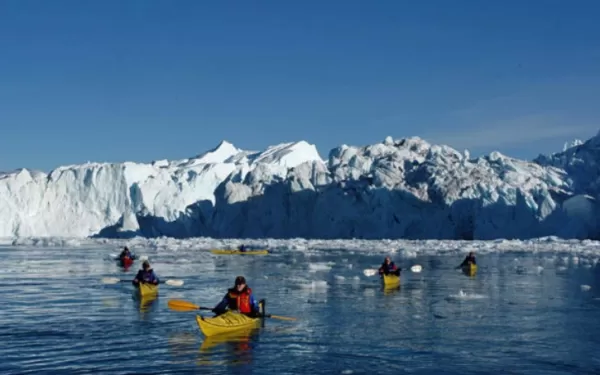 Kayak with massive icebergs