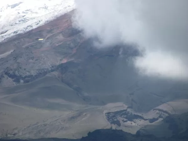 Cotopaxi in the clouds; the glacier used to come all the way down to the Base Camp at the center of the photo