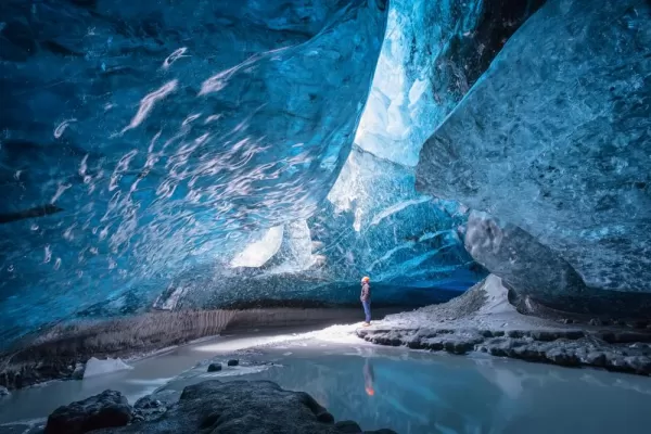 A man standing in Vatnajokull ice cave.