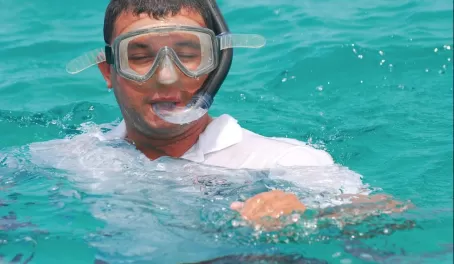 Luis snorkeling in the crystal blue waters of the Galapagos