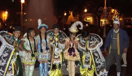 Walking in Cusco at night, dancers dressed in their finest.
