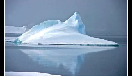 A ridgeback iceberg in calm seas.