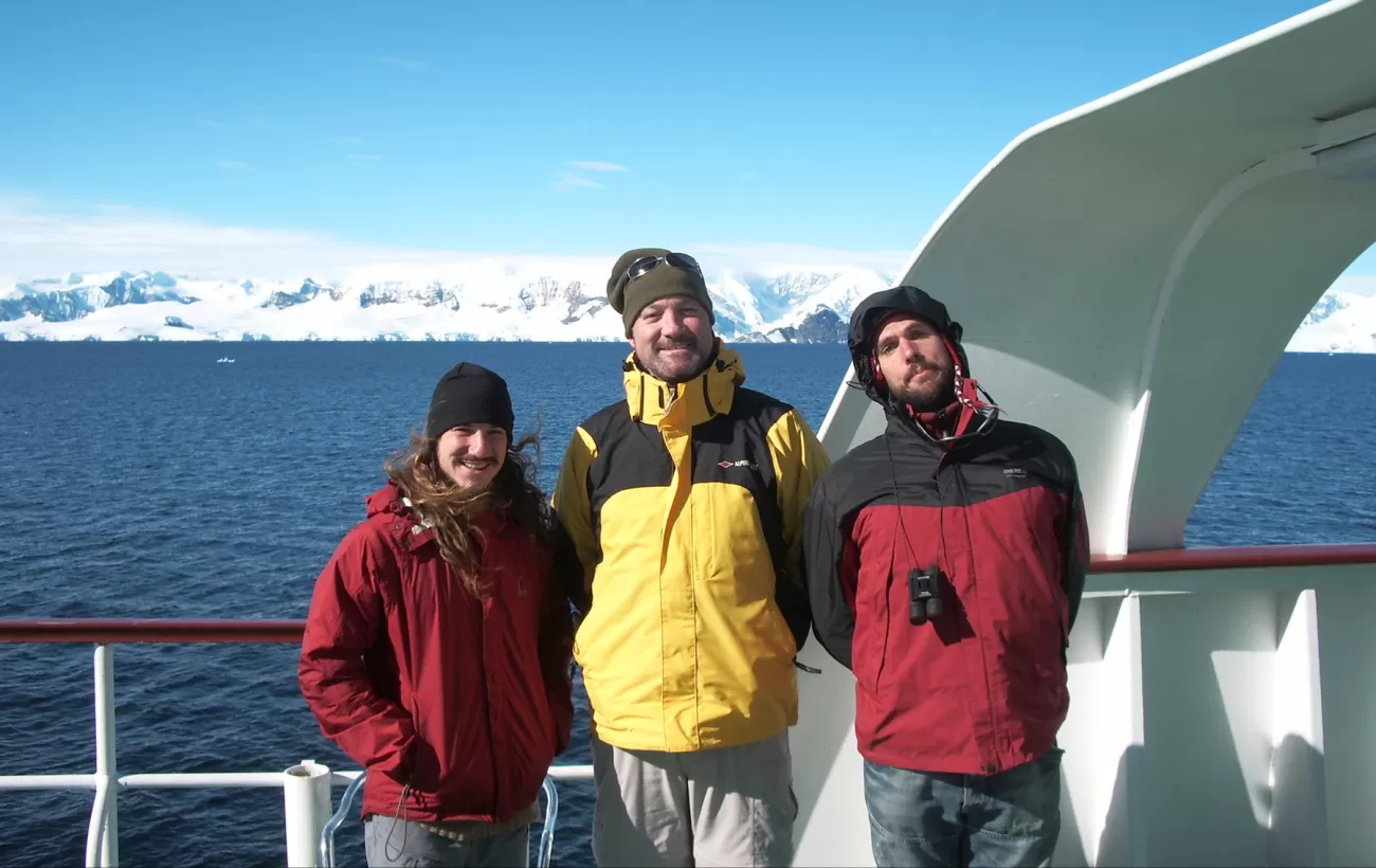 Travelers enjoying the brisk air and landscape on an Antarctica tour