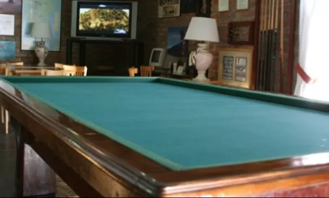 Guests enjoy the use of the pool table, flat screen TV, video library and more