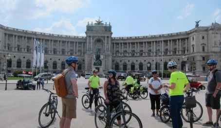 A group of cyclists touring the Hofburg Palace