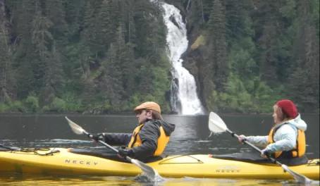 Kayaking past a waterfall