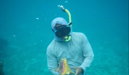Abel diving for a conch to show us
