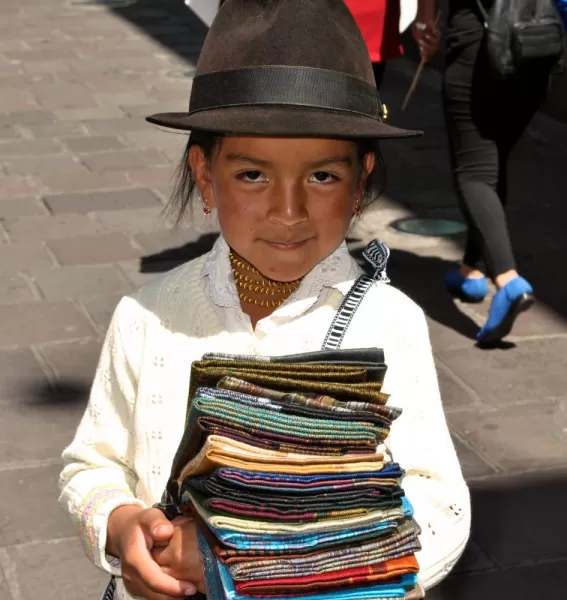 Adorable Peruvian girl selling scarves