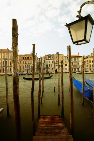 Gondola riding through a canal in Venice.