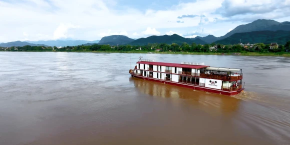Heritage Line Anouvong luxury cruise ship sailing on the Upper Mekong River in Laos