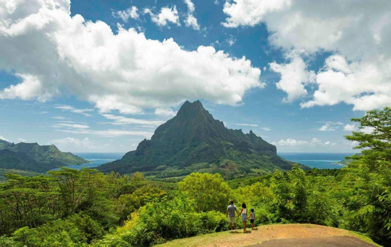 Travelers take in panoramic views of majestic Mount Rotui, dense green jungle valleys, and the ocean in Moorea
