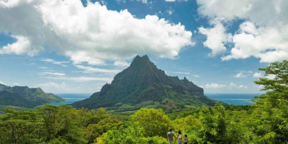 Travelers take in panoramic views of majestic Mount Rotui, dense green jungle valleys, and the ocean in Moorea