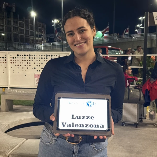 Alexandra with airport pickup sign