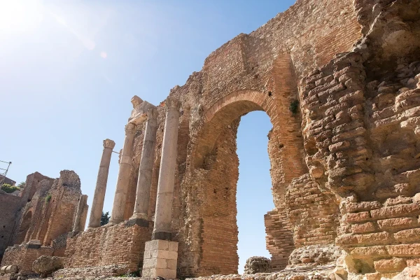 The surviving brick arches and Corinthian columns of the Ancient Theater of Taormina