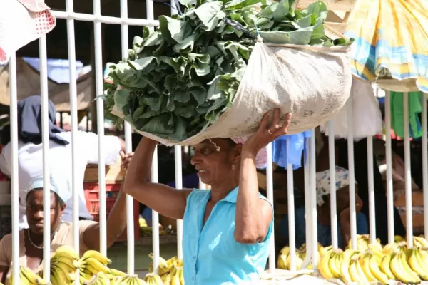 Local carrying food on her head.