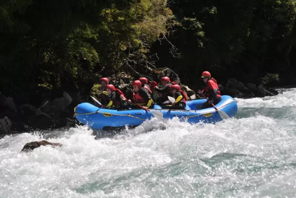Rafters take on the intense rapids with determination.