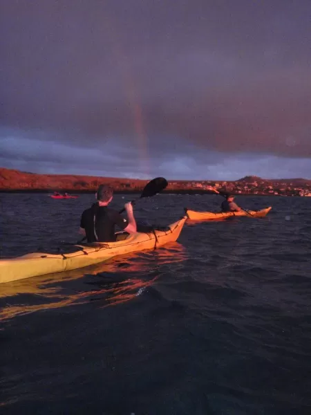 rainbow kayaking at sunset