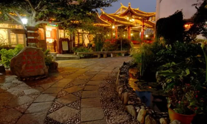 Outdoor night view of the Landscape Hotel and premises